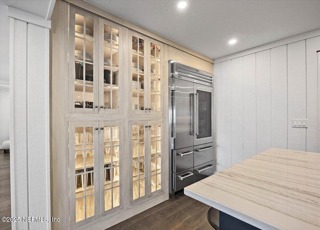 kitchen with dark hardwood / wood-style flooring and built in fridge