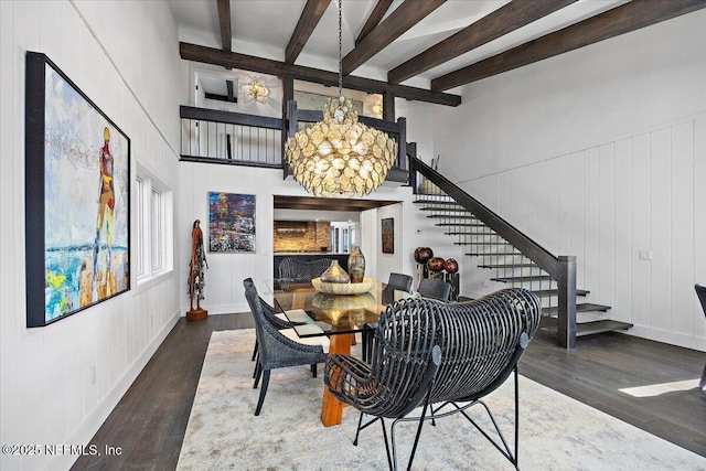 dining area with an inviting chandelier, beam ceiling, and dark wood-type flooring