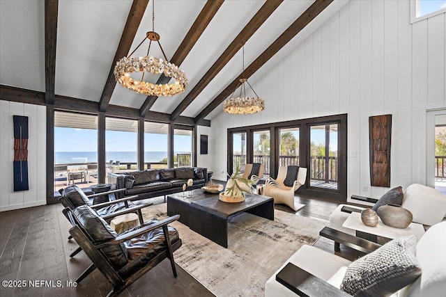 living room with an inviting chandelier, a water view, wood-type flooring, high vaulted ceiling, and beamed ceiling