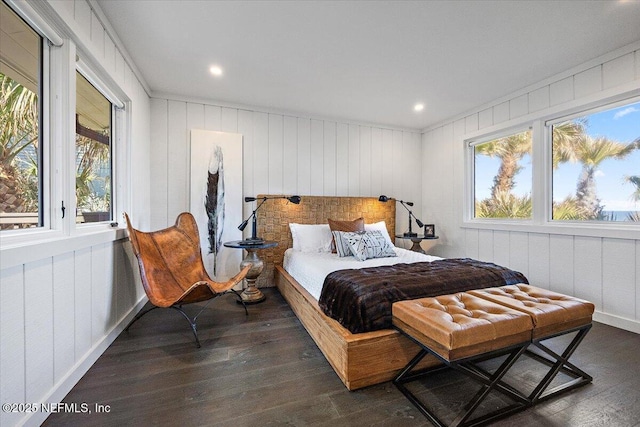 bedroom with dark hardwood / wood-style flooring and multiple windows