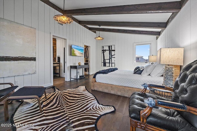 bedroom with lofted ceiling with beams, dark wood-type flooring, and a spacious closet