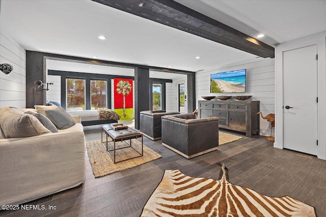 living room featuring dark hardwood / wood-style floors, beamed ceiling, and wood walls