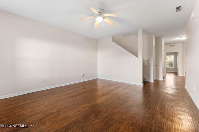 unfurnished living room featuring ceiling fan and dark wood-type flooring