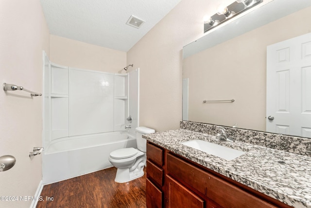 full bathroom with a textured ceiling, toilet, vanity, shower / bathtub combination, and hardwood / wood-style flooring