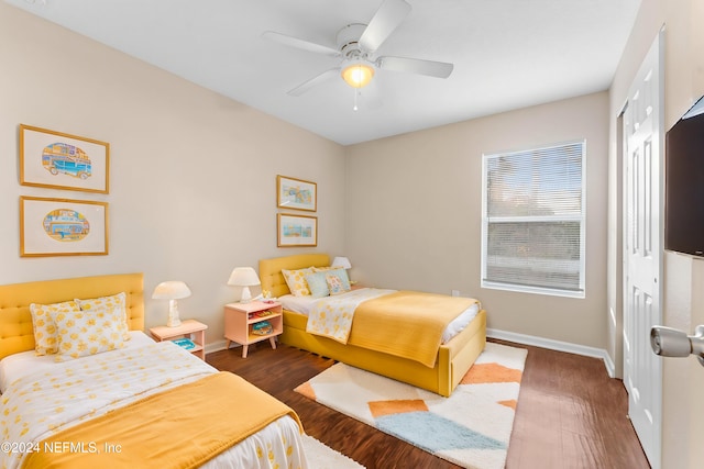 bedroom featuring a closet, ceiling fan, and dark wood-type flooring