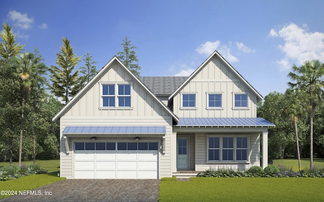 view of front of house with a garage and a front yard