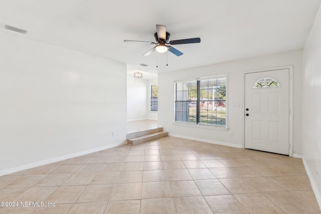 tiled foyer with ceiling fan