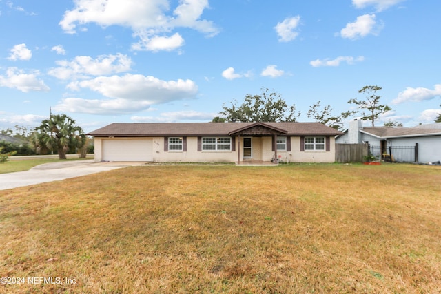 ranch-style home featuring a front yard and a garage