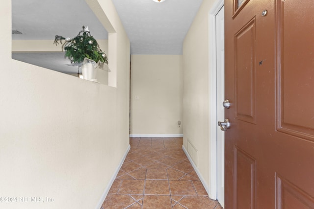 corridor with light tile patterned floors