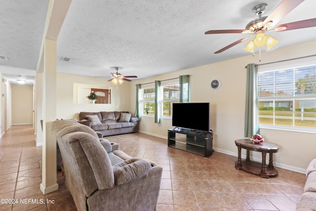 living room featuring light tile patterned floors and a textured ceiling