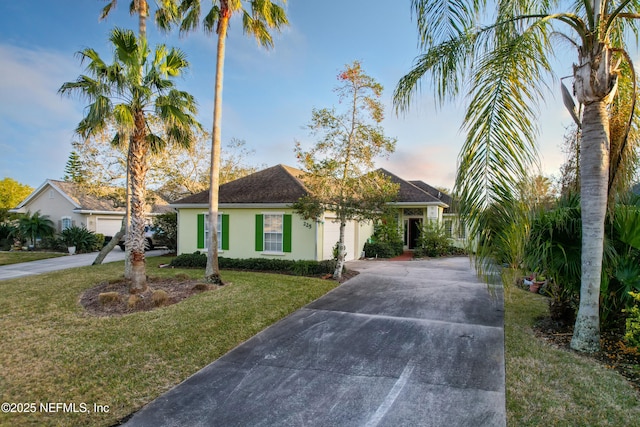 ranch-style home with a lawn