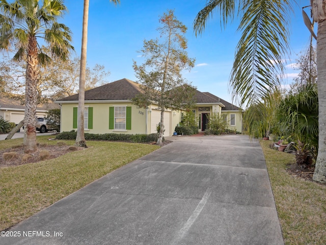 ranch-style home featuring a garage and a front yard