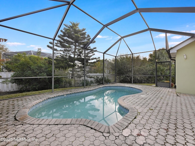 view of pool with a lanai and a patio