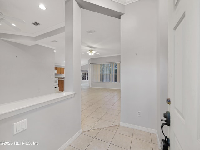 interior space featuring crown molding and light tile patterned floors