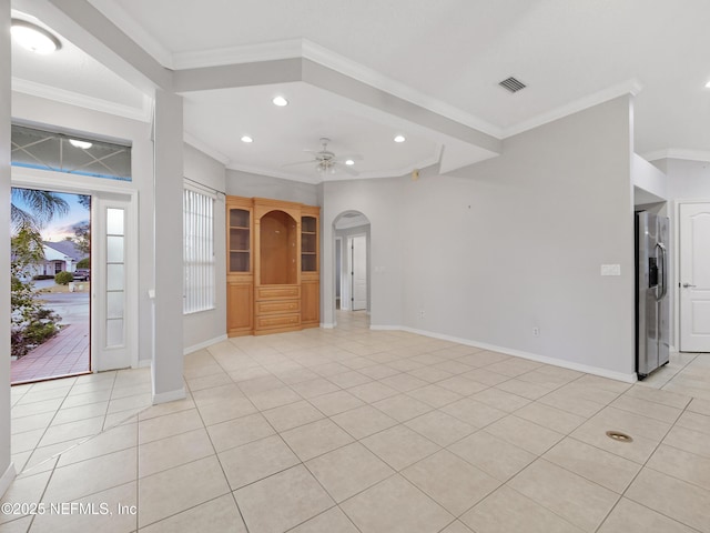 unfurnished living room featuring ceiling fan, ornamental molding, and light tile patterned floors