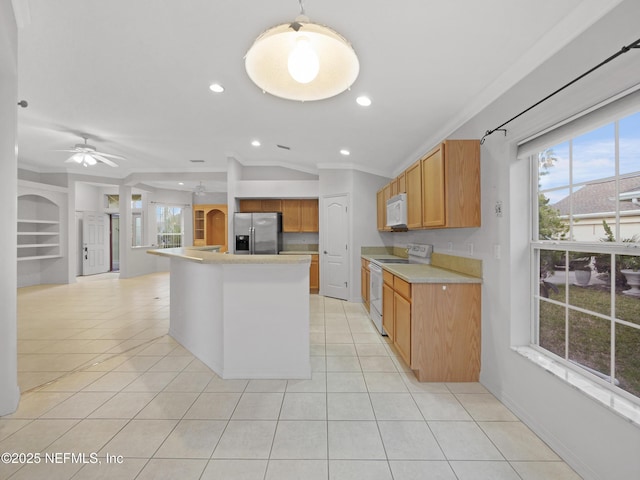 kitchen with lofted ceiling, a center island with sink, light tile patterned floors, white appliances, and a healthy amount of sunlight