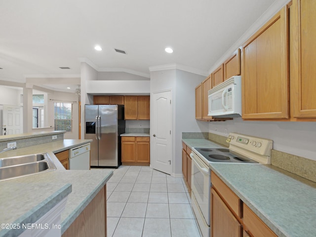 kitchen with crown molding, sink, white appliances, and light tile patterned flooring