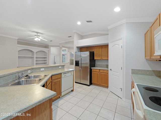 kitchen with ornamental molding, sink, light tile patterned floors, and white appliances