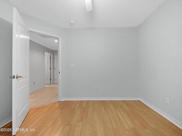 spare room with ceiling fan and light hardwood / wood-style floors