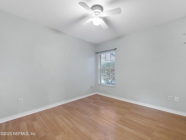 empty room featuring ceiling fan, light hardwood / wood-style flooring, and a textured ceiling