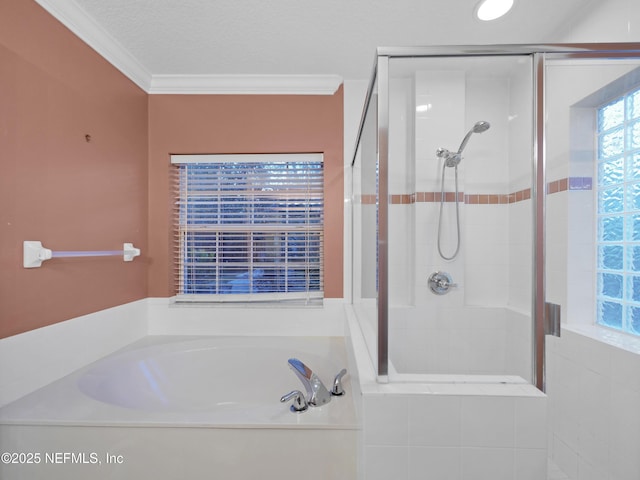 bathroom featuring independent shower and bath, ornamental molding, and a textured ceiling