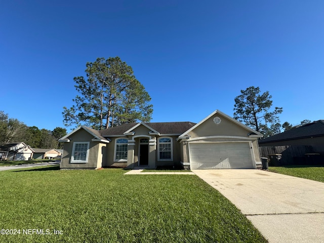 ranch-style home with a garage and a front lawn