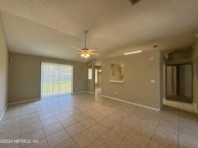 tiled spare room featuring ceiling fan and a textured ceiling