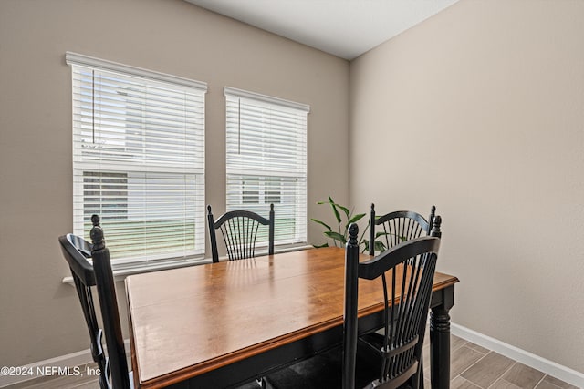 dining room featuring a healthy amount of sunlight and hardwood / wood-style flooring