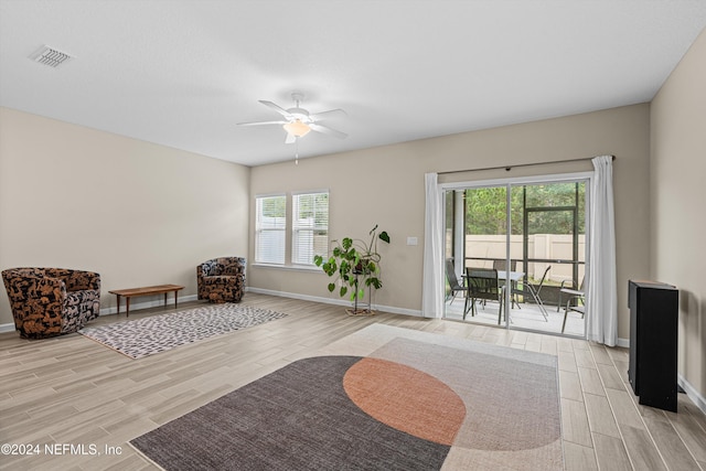 sitting room featuring light hardwood / wood-style flooring and ceiling fan