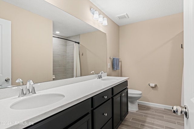 bathroom with toilet, vanity, and a shower with shower curtain