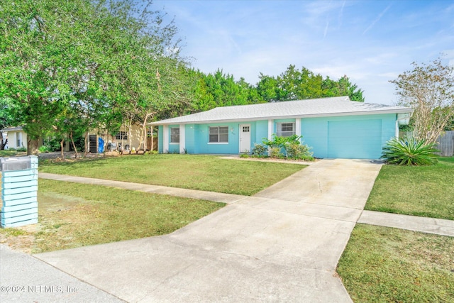 view of front of house featuring a garage and a front lawn