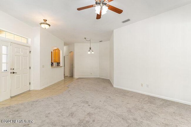 carpeted foyer featuring ceiling fan