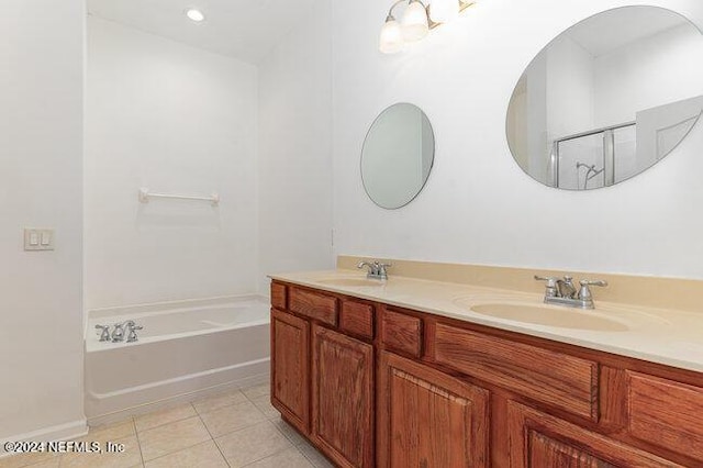 bathroom with vanity, tile patterned floors, and a tub