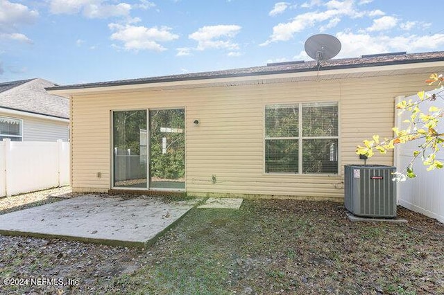 back of house with central air condition unit and a patio