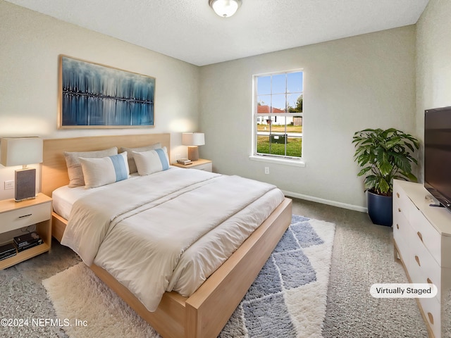 carpeted bedroom with a textured ceiling