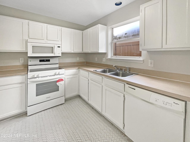 kitchen with white cabinets, white appliances, and sink