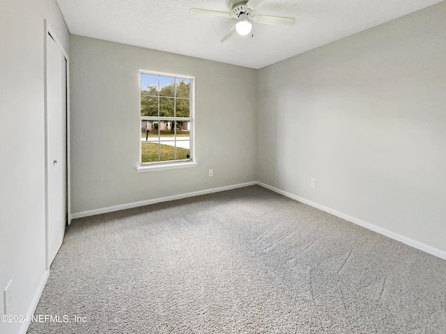 unfurnished bedroom featuring a textured ceiling, carpet floors, a closet, and ceiling fan