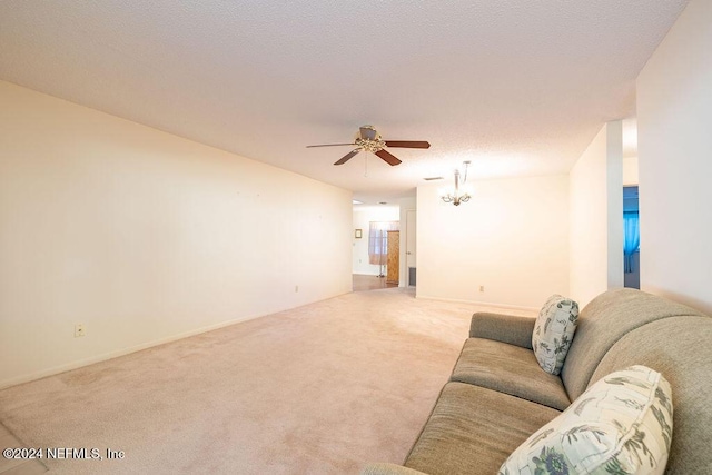 unfurnished living room featuring carpet and ceiling fan