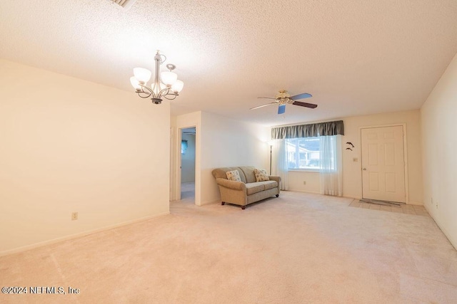 unfurnished room featuring carpet flooring, ceiling fan with notable chandelier, and a textured ceiling