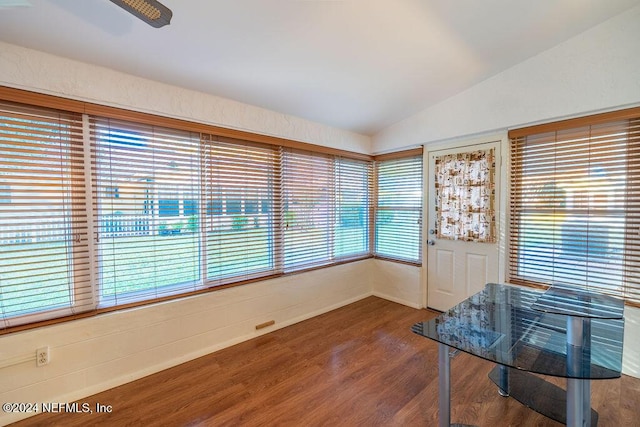 interior space with ceiling fan, wood-type flooring, and vaulted ceiling