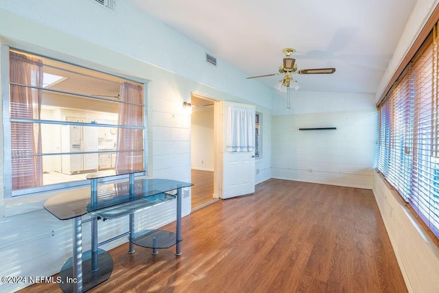 interior space with wood-type flooring, ceiling fan, and lofted ceiling