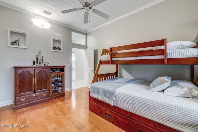 bedroom with ceiling fan, light wood-type flooring, and ornamental molding