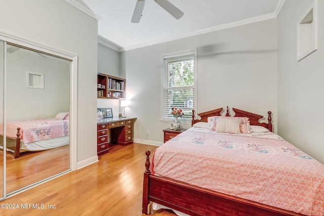 bedroom featuring ceiling fan, a closet, crown molding, and hardwood / wood-style flooring