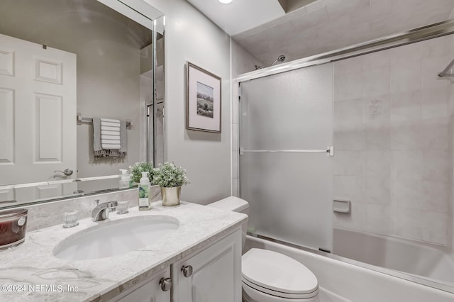 full bathroom with vanity, toilet, and enclosed tub / shower combo