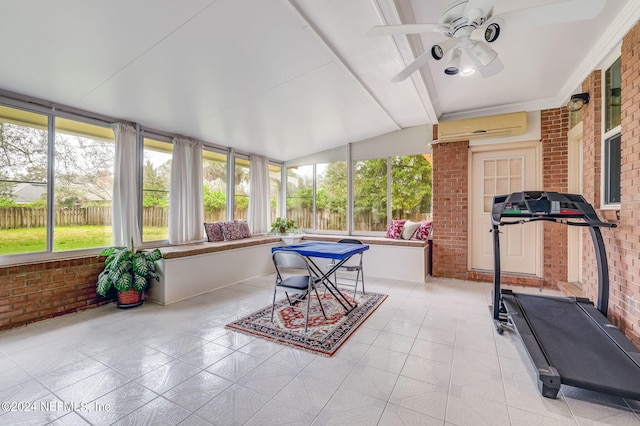 sunroom featuring ceiling fan, lofted ceiling, and a wall unit AC