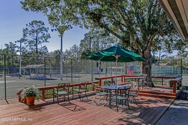 wooden deck with tennis court