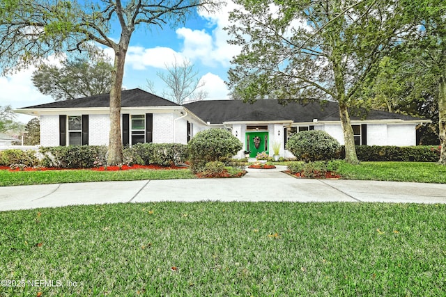 ranch-style home with a front lawn