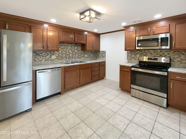 kitchen featuring light tile patterned floors, backsplash, stainless steel appliances, and sink