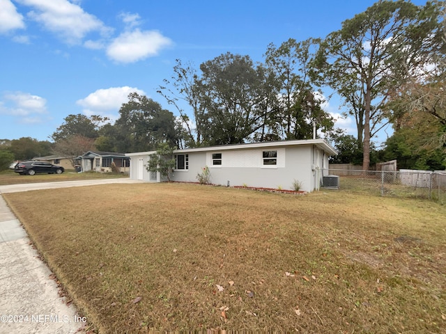 view of front of house with a front yard and central AC unit