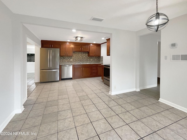 kitchen with decorative backsplash, pendant lighting, stainless steel appliances, and light tile patterned flooring